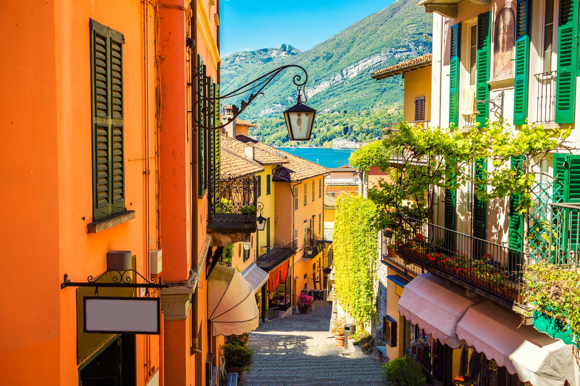 The iconic cobblestone alleyways of Bellagio, the "Pearl of Lake Como." This picturesque street is lined with traditional trattorias and artisan shops, offering an authentic Italian travel experience.