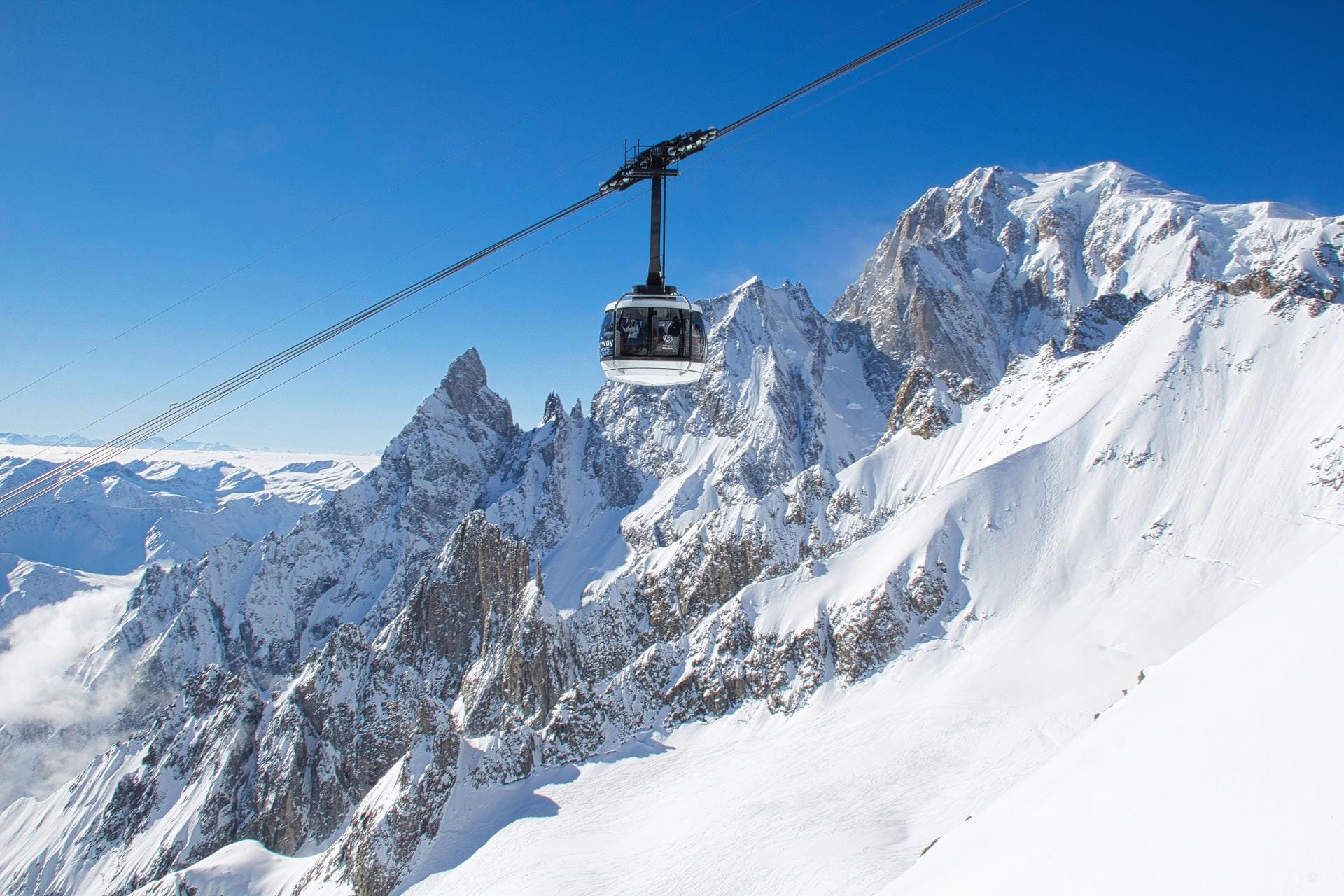 The rotating SkyWay Monte Bianco cable car ascending toward Punta Helbronner in the Aosta Valley, near Mont Blanc.