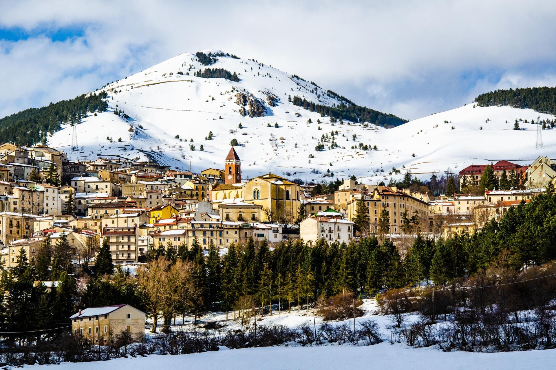 The snow-covered slopes and historic architecture of Rivisondoli and Roccaraso in the Abruzzo region.