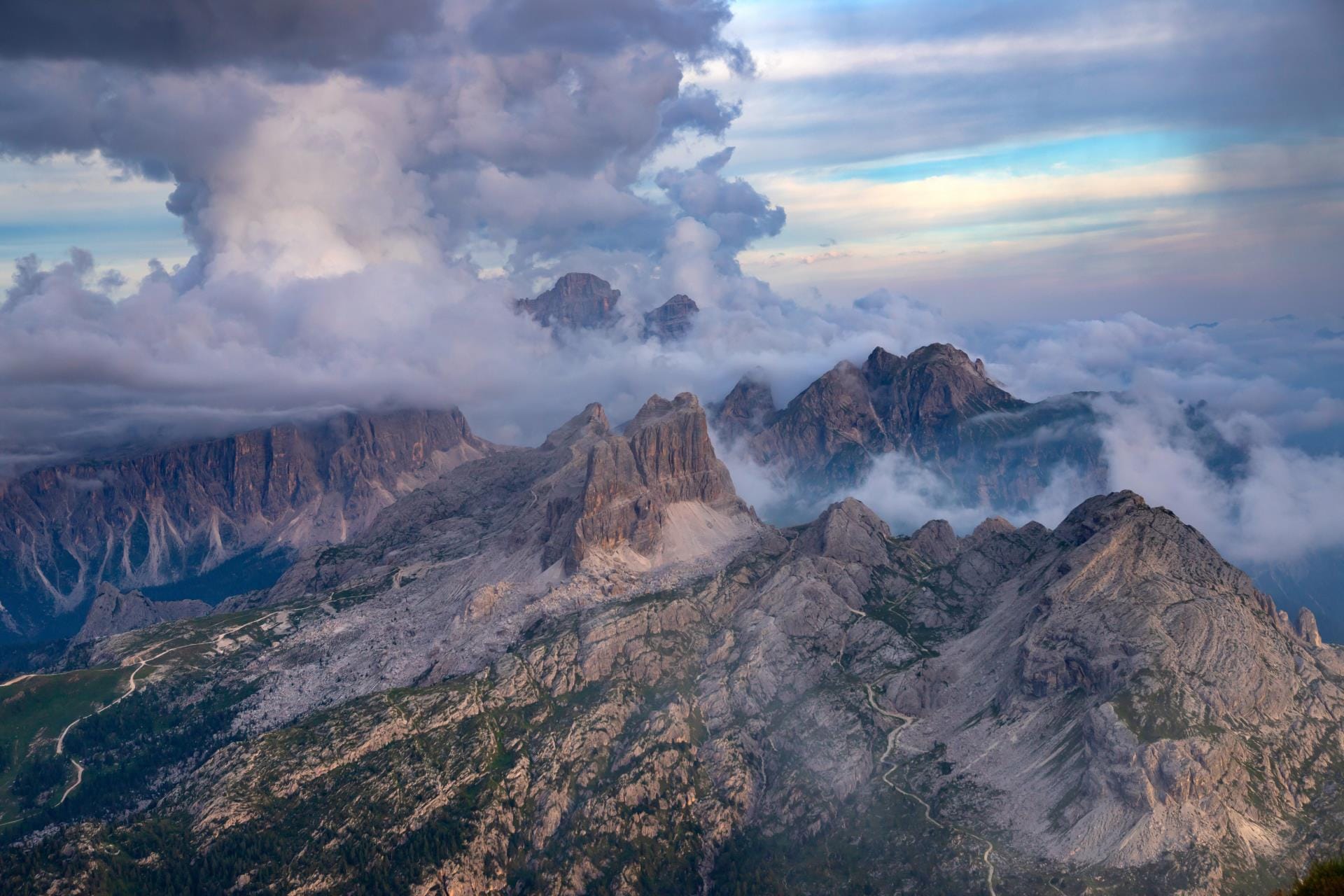 Golden hour sunset over the snow-covered Dolomite peaks viewed from the high-altitude Lagazuoi refuge.
