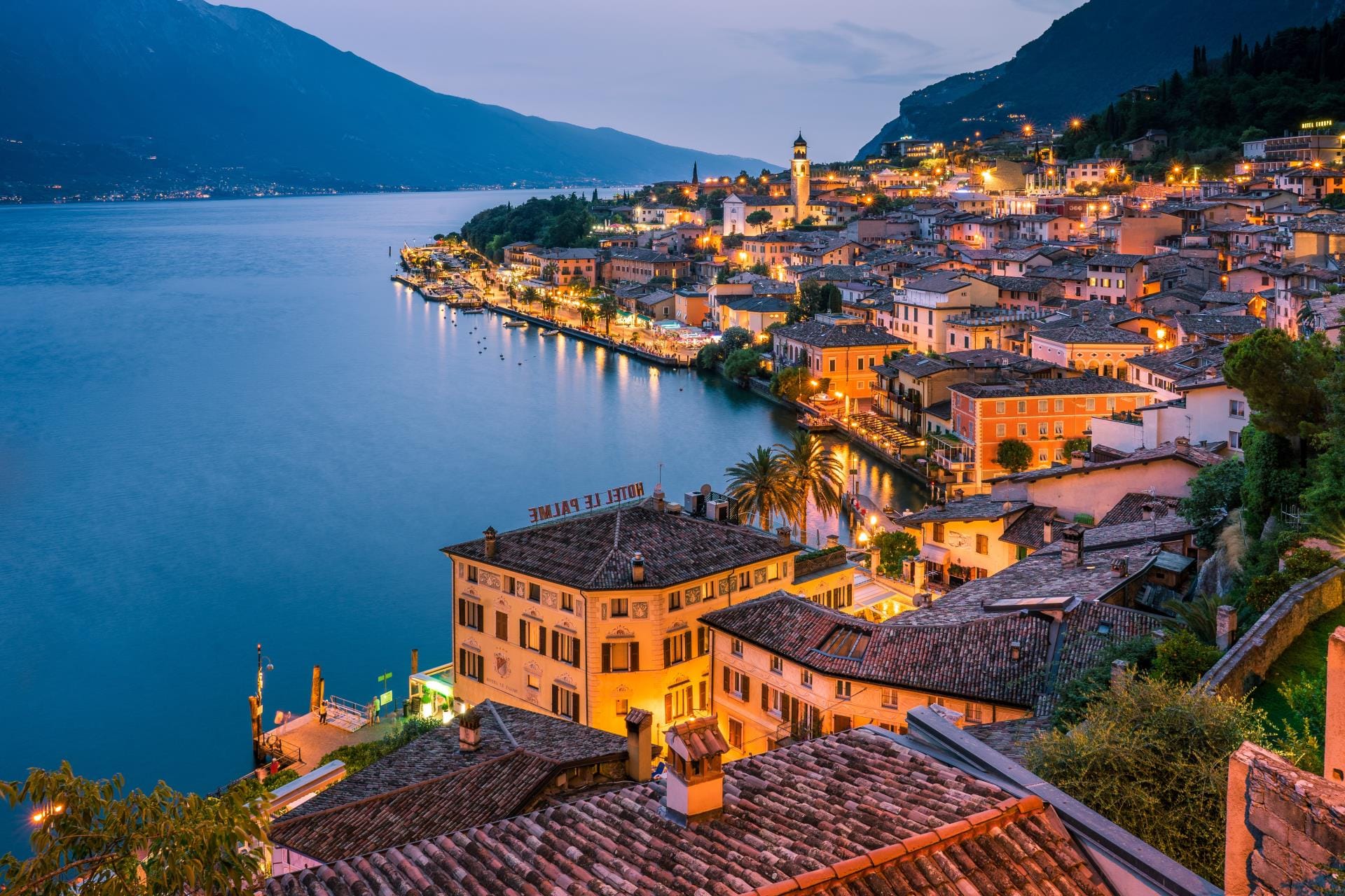 A panoramic view of the village of Limone sul Garda on the western shore of Lake Garda in Lombardy during the golden blue hour.